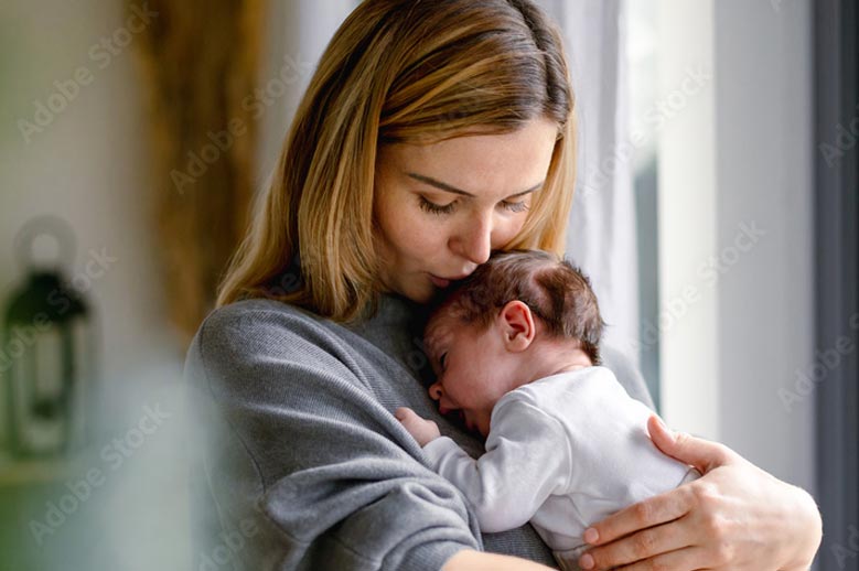 Woman holding newborn baby